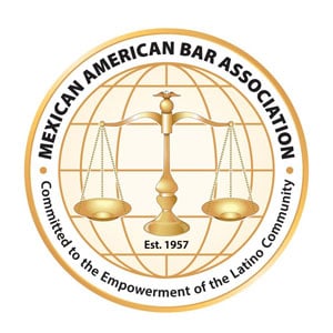 Logo of the Mexican American Bar Association featuring a stylized eagle and scales of justice in a circular design.